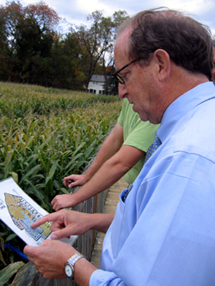 Photo of Secretary Fisher looking at the corn maze map