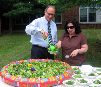 Photo of Secretary Fisher and parent volunteer serving at Salad Extravaganza