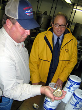 Photo of Todd Reeves and Secretary Fisher with shucked oyster
