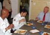 Photo of Erik Weatherspool, Peter Fischbach and Secretary Kuperus enjoying the dish