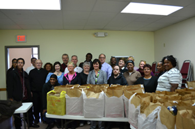 Photo of Secretary Fisher with St. Andrew-Resurrection Food Pantry volunteers