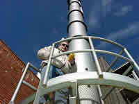 Inspector conducting a stack test at an industrial facility. 