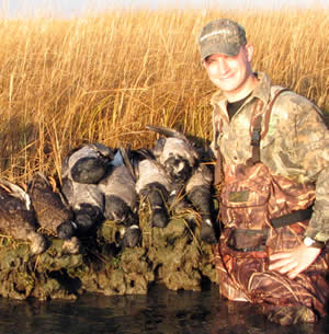 Hunter with brant and black ducks