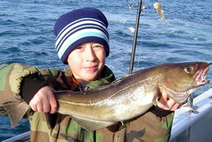 Young angler with cod
