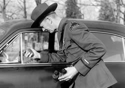 Warden uses an early car radio