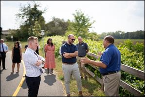 DEP Commissioner LaTourette (left) and Chief Climate Resilience Officer Nick Angarone (center) speak with Delran Township Mayor Gary Catrambone (right) during a tour of Burlington County