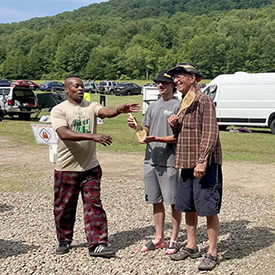 The Delaware River Sojourn's Dejay Branch (L) presents 1,000 mi paddles to two people. Photo by the DRBC.