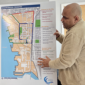 A person discusses community projects using a map showing neighborhood priorities in Camden. Photo by the DRBC.