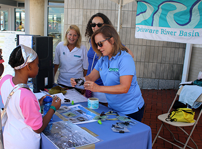(From L to R) DRBC's Donna Woolf, Stacey Mulholland, and Denise McHugh talk with festival attendees about why aquatic creatures need clean water to live in. Photo courtesy of the Partnership for the Delaware Estuary.