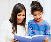 Photo of adult reading to a child