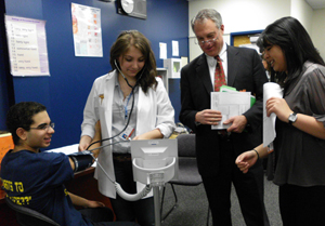 Students at the Union County Vocational Technical Schools show NJDOE acting Commissioner Chris Cerf how to take a blood pressure reading.