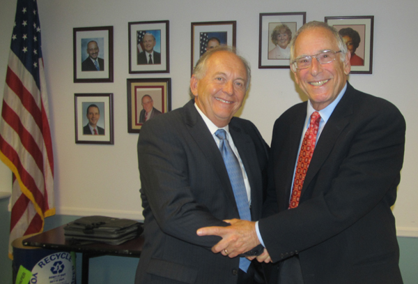 Former Board Vice President Ronald Butcher, left, congratulates Ilan Plawker as the newly elected vice president of the State Board of Education.