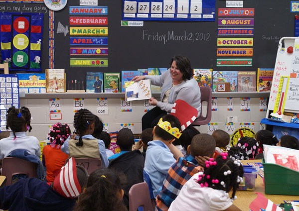 Department of Children and Families Commissioner Allison Blake reads to kindergarteners at Trenton’s PJ Hill Elementary School.