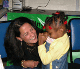 Commissioner Jennifer Velez meets a child at Starting Points for Children, a community-based organization in Jersey City, whose family enrolled her in NJ FamilyCare through the Express Lane Eligibility initiative.