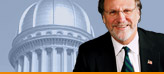 Photo of Governor Corzine in front of the New Jersey State House Dome