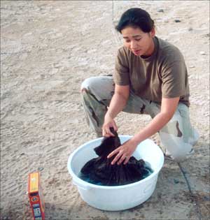 Spc. Donna Dela Vega and the rest of the 253rd resort to the tried and tested methods of washihg in the field