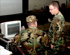 Sgt. 1st Class Samuel Grimes, confers with a T3BL staff member during weapons qualifications