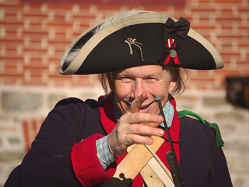A Continental soldier demonstrates how to load a weapon during Patriots' Week