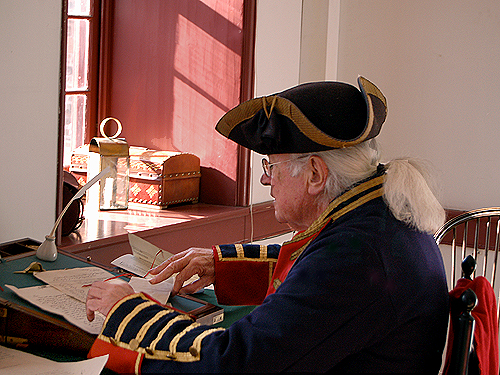 The Officer of the Day prepares work orders at his desk in the officers' quarters