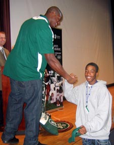 Photo of Brick handing a prize to a student at PCTI