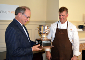 Photo of Secretary Fisher and Chris Albrecht with the trophy - Click to enlarge