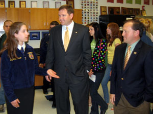 Photo of Jenny Allen showing the Assemblymen the new ag facility