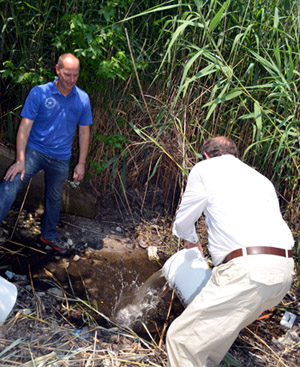 Photo of Peter Bosak and Secretary Fisher releasing copepods in Cape May County