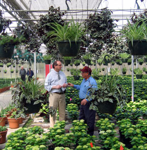 Photo of Secretary Fisher and Carmen La Rosa in the greenhouse