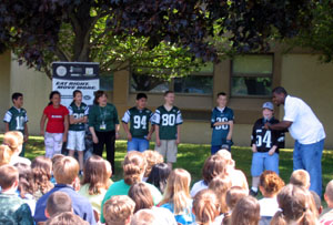 Photo of Principal Denise LaBov, Adrien Clarke and students leading Jets cheer