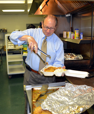 Photo of Secretary Fisher packing a lunch 