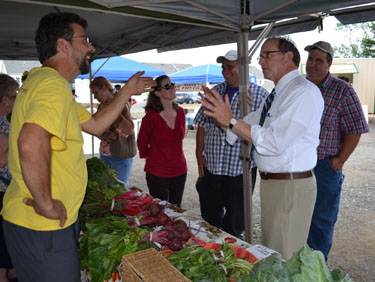 Secretary Fisher visits a farmer at the Robbinsville Farmers Market