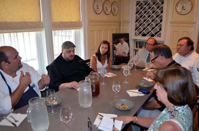 Photo of Secretary Fisher tasting the Chef Gregg's dish