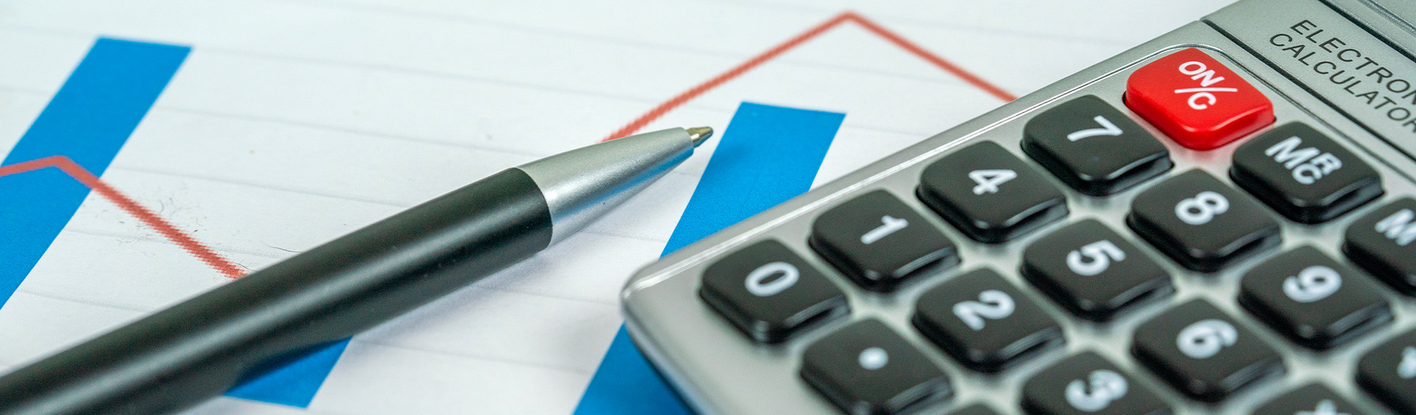 Photo: Calculator, charts, pen, calculating figures