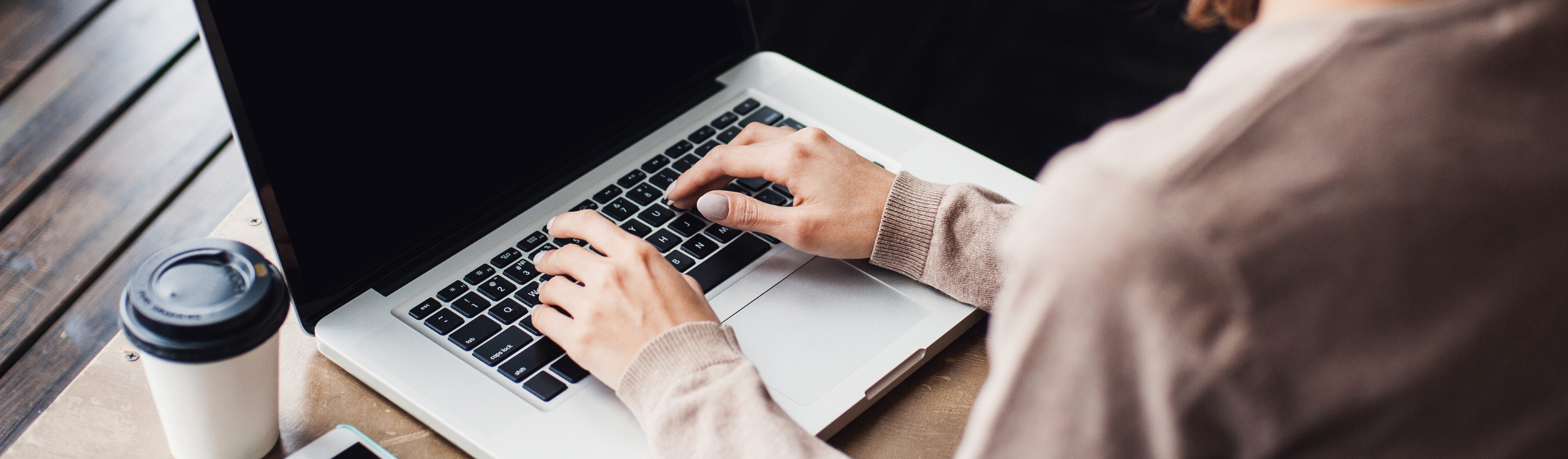 Hands typing on a laptop kayboard