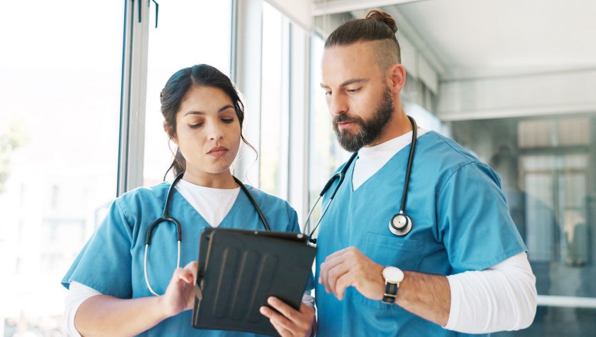 two nurses male and female talking