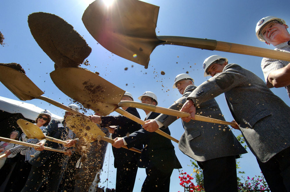 several people shoveling dirt