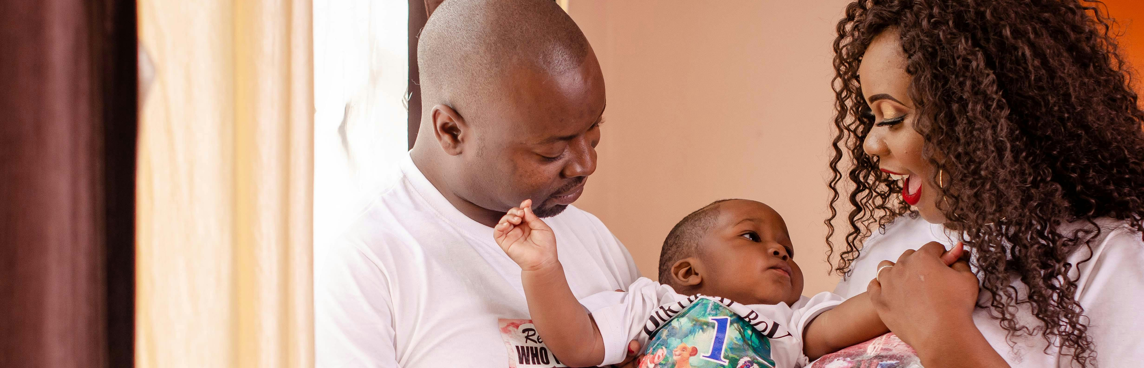 Parents holding their baby caringly with laughter