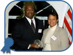 NJDEP Commissioner Lisa Jackson awards the Governor's Environmental Excellence Award for Environmental Leadership to Dr. Kevin Lyons, Director of Purchasing at Rutgers University for his applied research and implementation of environmentally-friendly and socially-responsible purchasing at the University.
