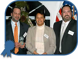NJDEP Commissioner Lisa Jackson awards the Governor's Environmental Excellence Award for Innovative Technology to Robert Burke (left) and Robert Kaplan (right), co-owners of Wayne Auto Spa Acquisition, LLC for its environmental and energy conservation initiatives.