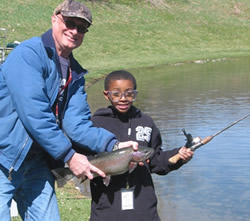 Volunteer and youngster with catch