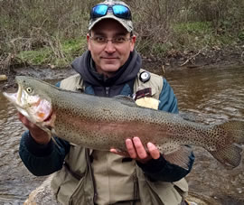 Angler with rainbow trout breeder