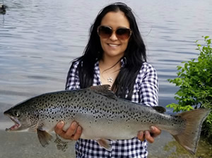 Runelvy Rodriguez with her state record salmon