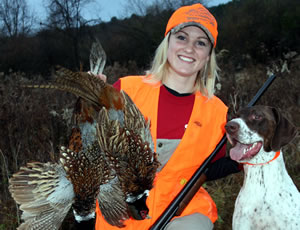 Hunter with pheasants and her dog
