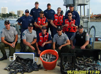Officers with seized fish