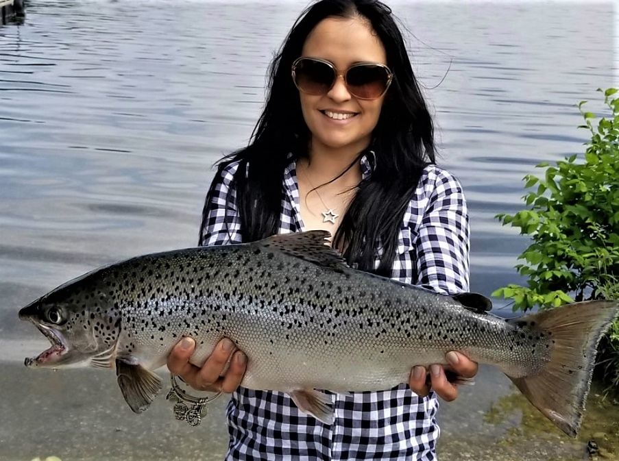 Runelvy Rodriguez of Northvale shows off her state record 25 3/4-inch landlocked salmon, caught June 2, 2018 in Lake Aeroflex