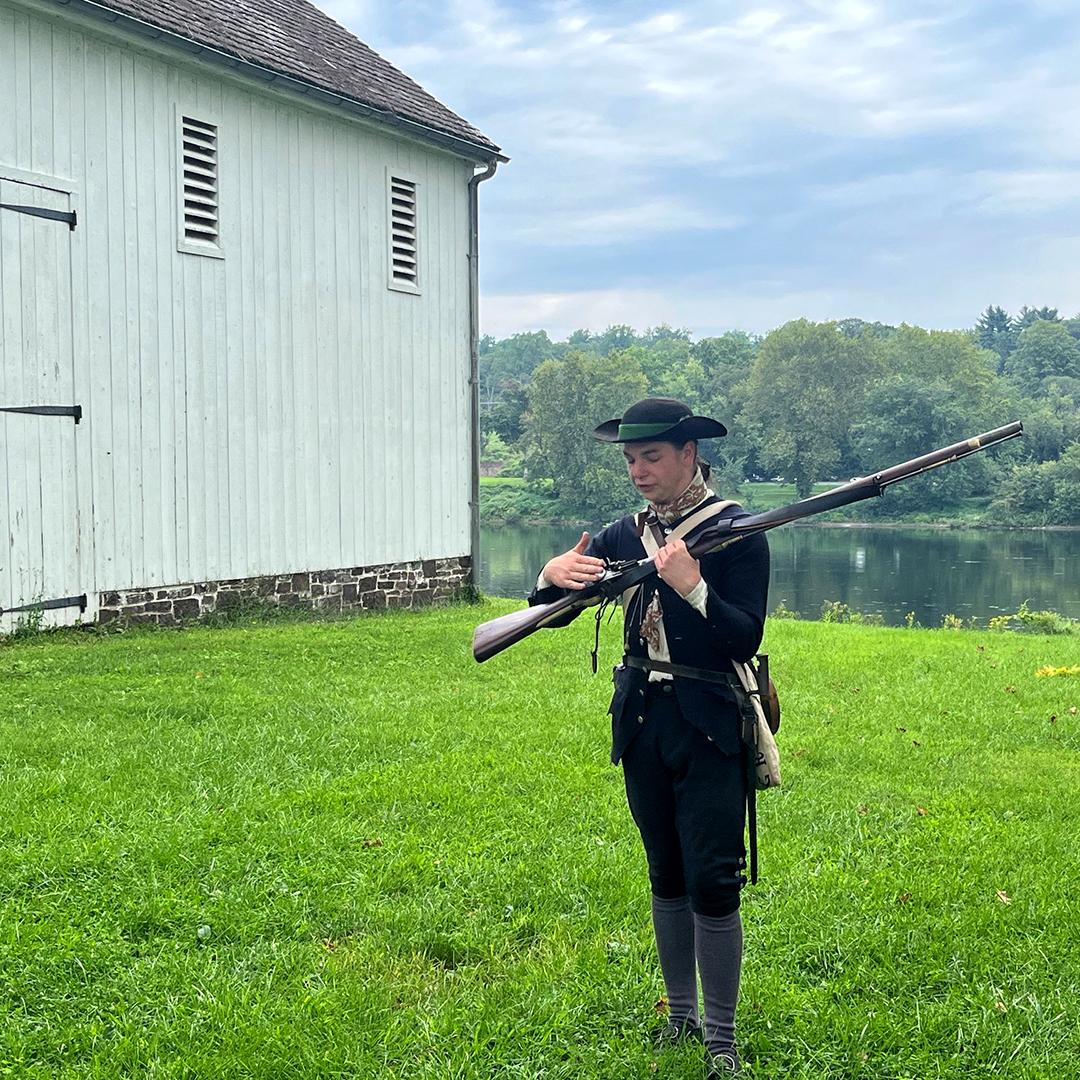 Friends of Washington Crossing Park's Alex Robb shows how to fire a musket. Photo by the DRBC.
