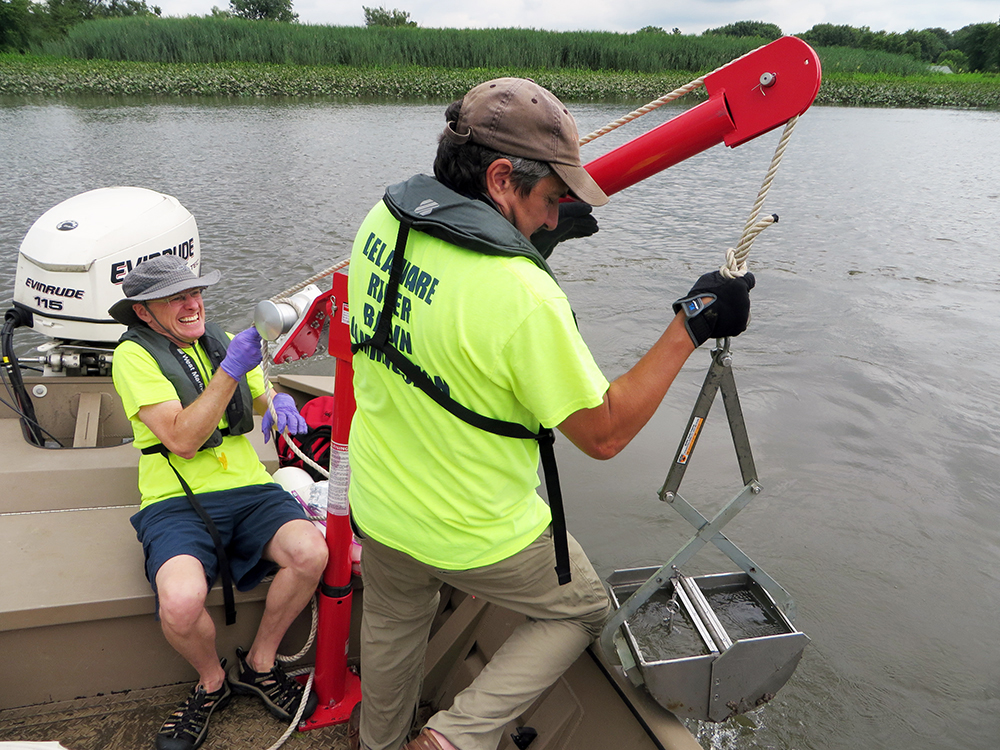 DRBC staff collect a sediment sample from a Delaware Estuary tributary. Photo by DRBC.