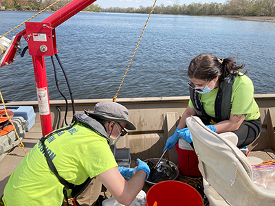 DRBC staff collects a sediment sample from the Delaware River to monitor for PFAS. Photo by DRBC.