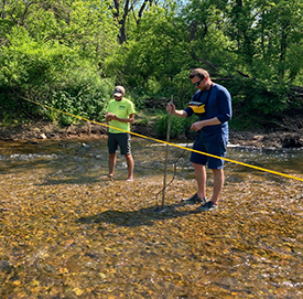 DRBC staff collects flow measurements at Pohatcong Creek, one of the chlorides study sites. Photo by DRBC.