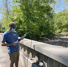 DRBC staff prepare the water quality probe before deployed into the creek. For many sites, sampling occurs from a bridge, with equipment lowered over the side. Photo by DRBC.